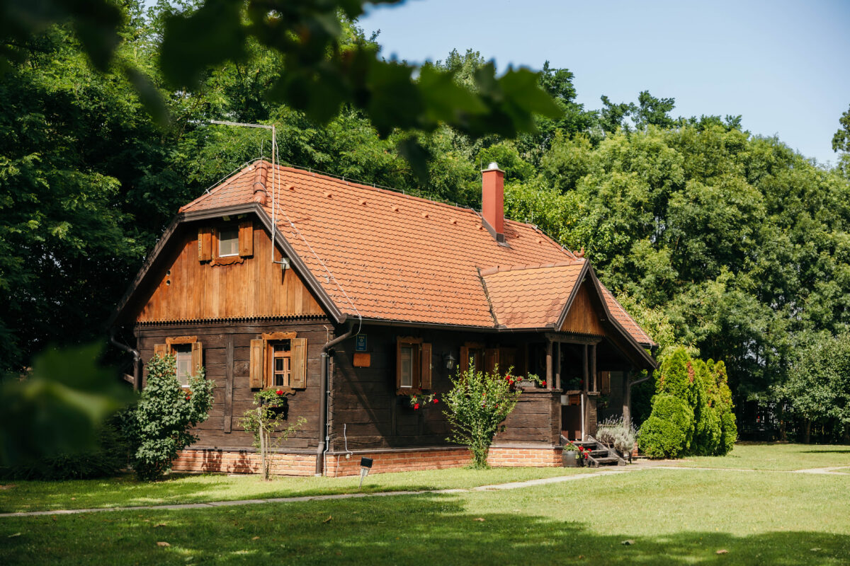 Tradicionalna drvena kuća za odmor okružena zelenilom